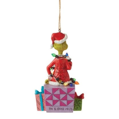 Click images to enlarge...Additional ImagesThe Grinch Wrapped in Lights Hanging Ornament6012709With a grimace on his green grouchy face, the Grinch, by Jim Shore, pendente natal grinch navidad